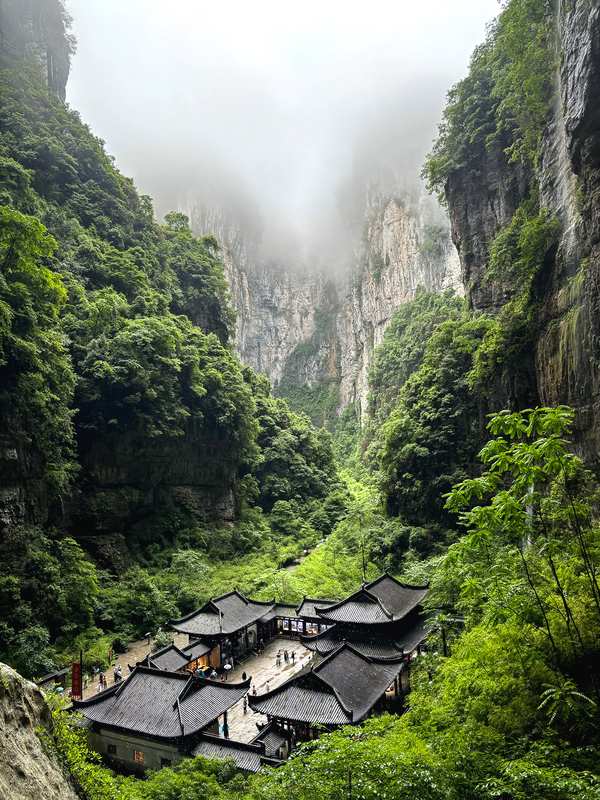 Three Natural Bridges Wulong Karst National Park stone arches through fog