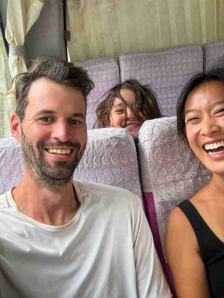 Corry and Ling smiling with fellow hiker and family on pin che minivan during Tiger Leaping Gorge journey