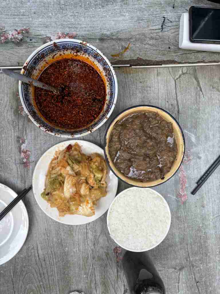 Traditional Xi'an Shaanxi cuisine featuring spicy chili oil, braised meat, and white rice.