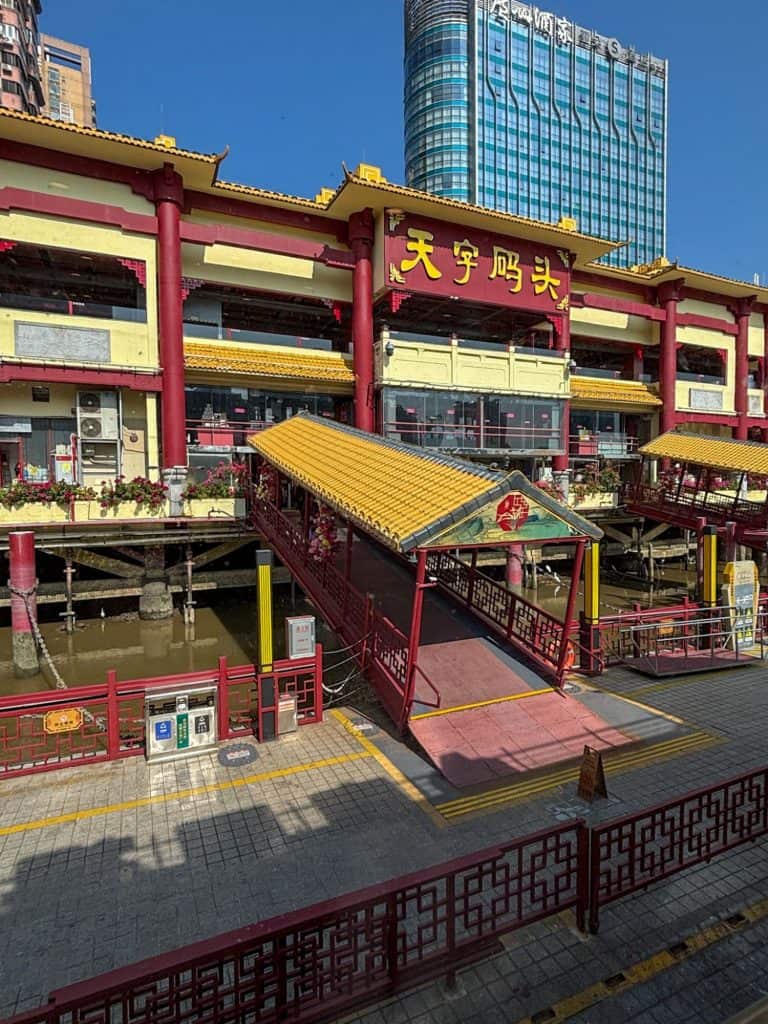 The yellow and red traditional Chinese exterior of Tianzi Wharf boat restaurant in Guangzhou.