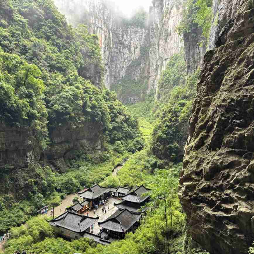 Scenic mountain landscape with fog over the Wulong Karst peaks.