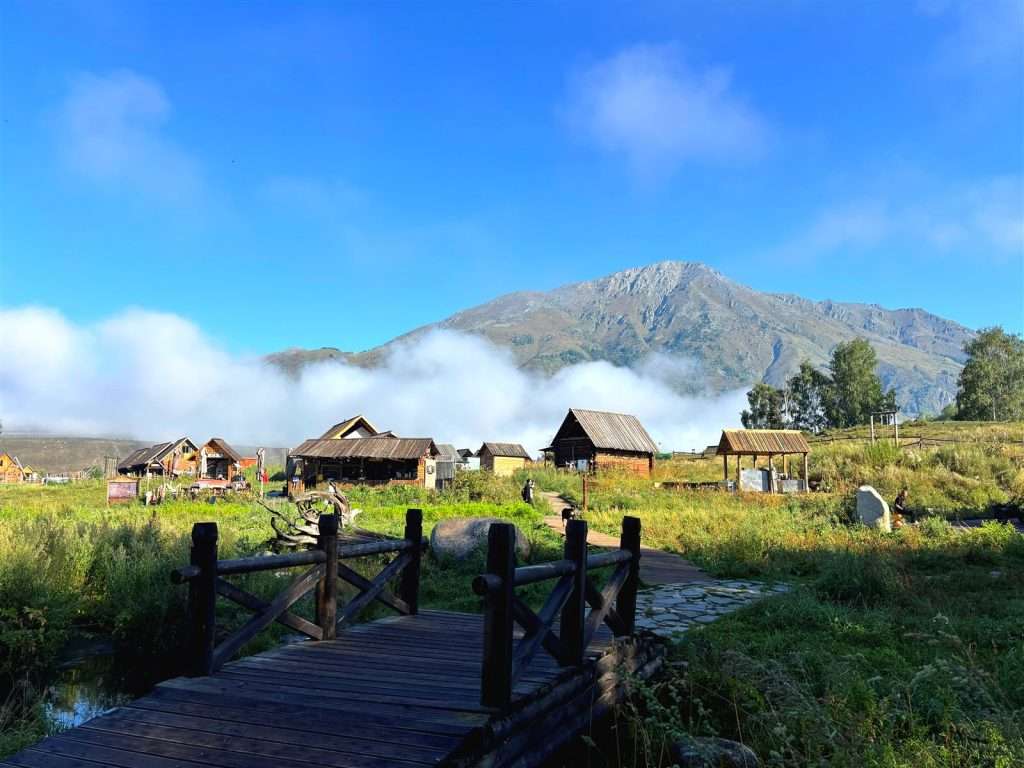 Sunrise viewing platform view over Hemu Village, layers of morning mist rolling through the valley