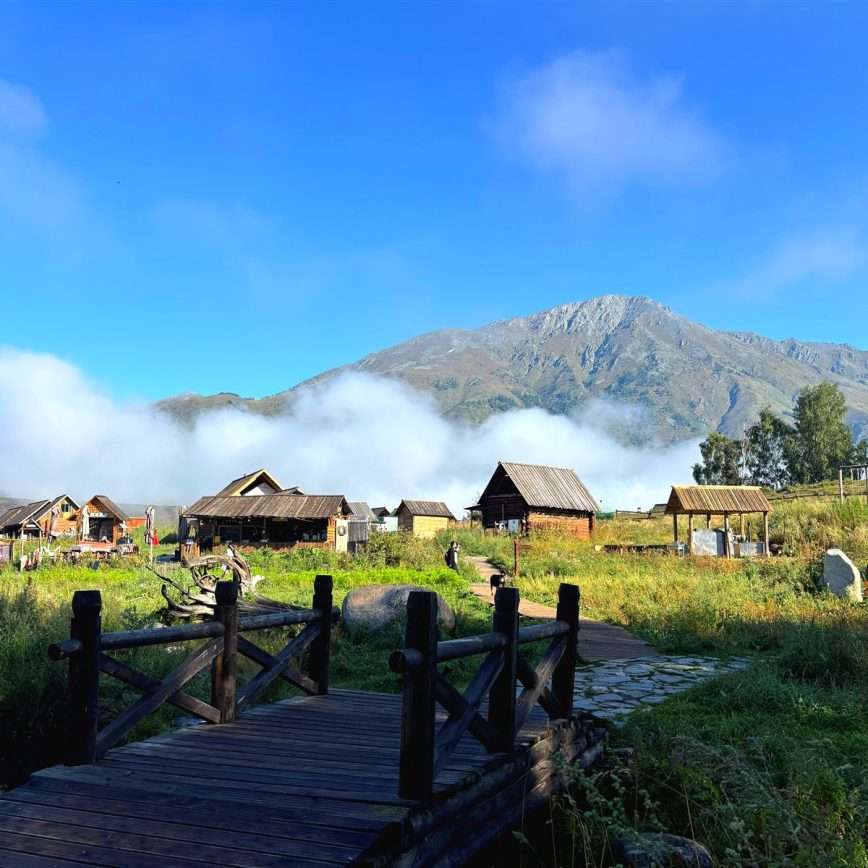 Sunrise viewing platform view over Hemu Village, layers of morning mist rolling through the valley